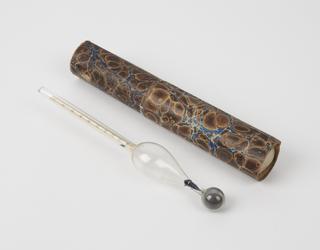 Glass hydrometer in cylindrical cardboard tube