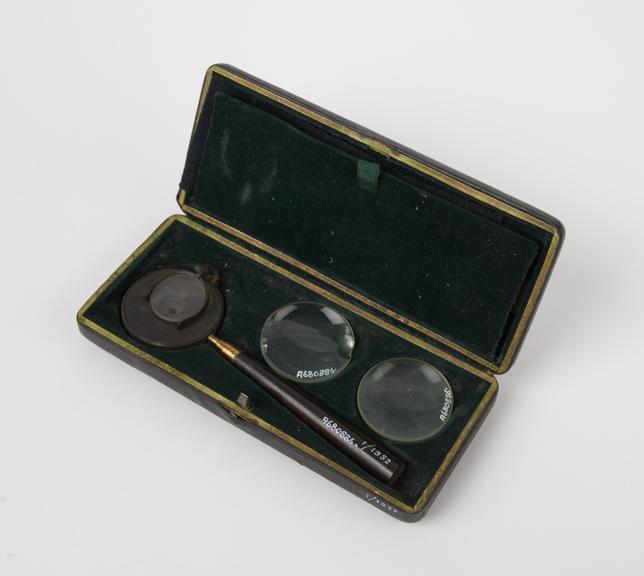 Liebreich's type ophthalmoscope with 7 lenses in green leather covered