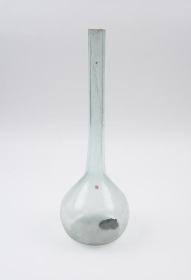 Pale green glass flask, bulbous body, long tubular neck