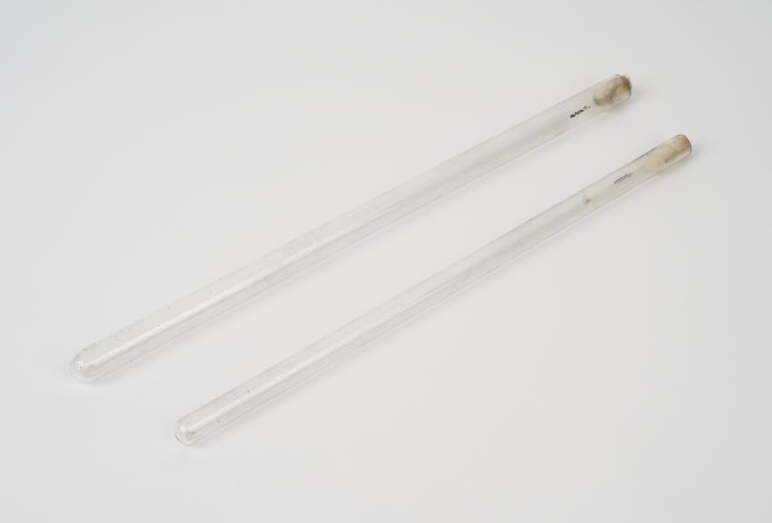 Two clear glass test tubes, tubular, possibly English