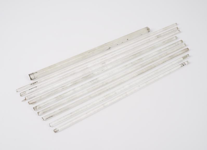 9 thin, and one thick, solid glass rods, English (?), 1880-1920