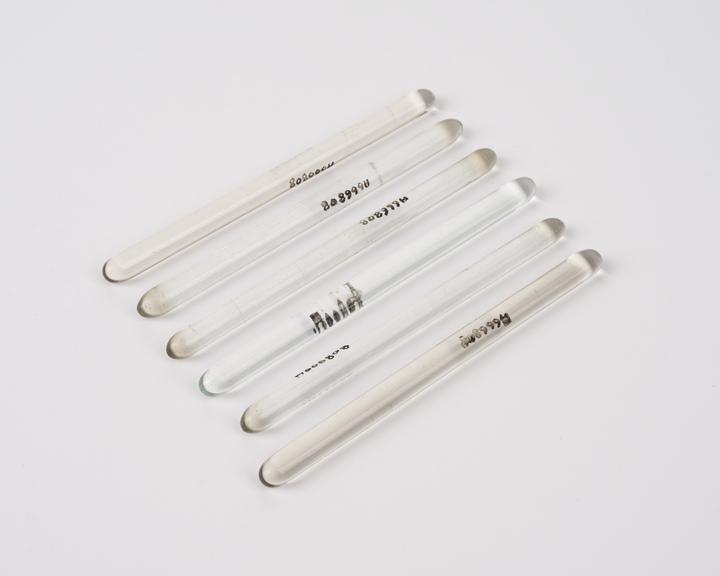 Six cylindrical glass rods with gently rounded ends, European