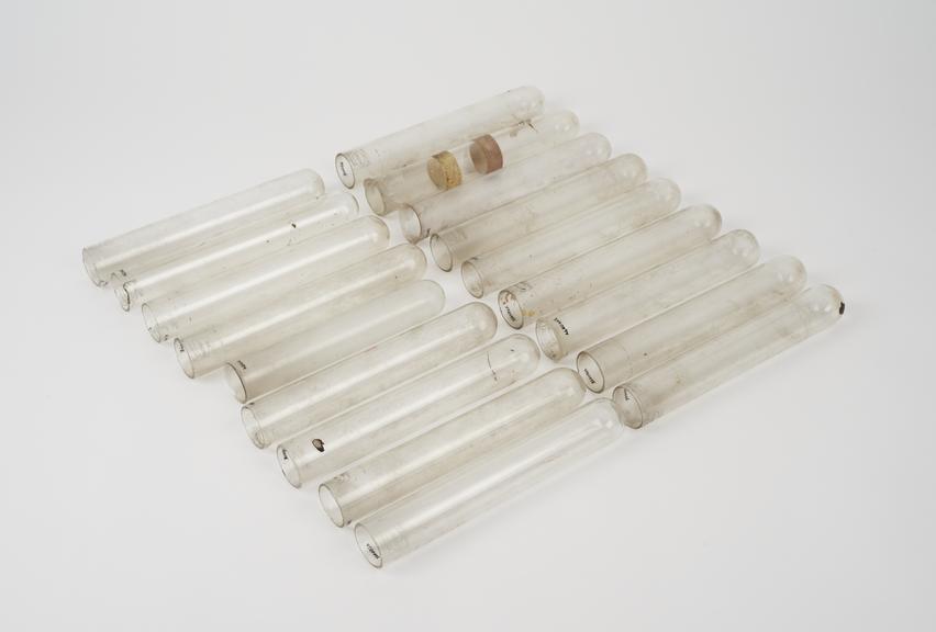 Eighteen clear glass test tubes, 1 of which made by Moncrieff