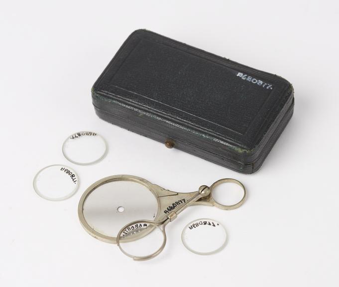 Ophthalmoscope and four lenses in leather covered case