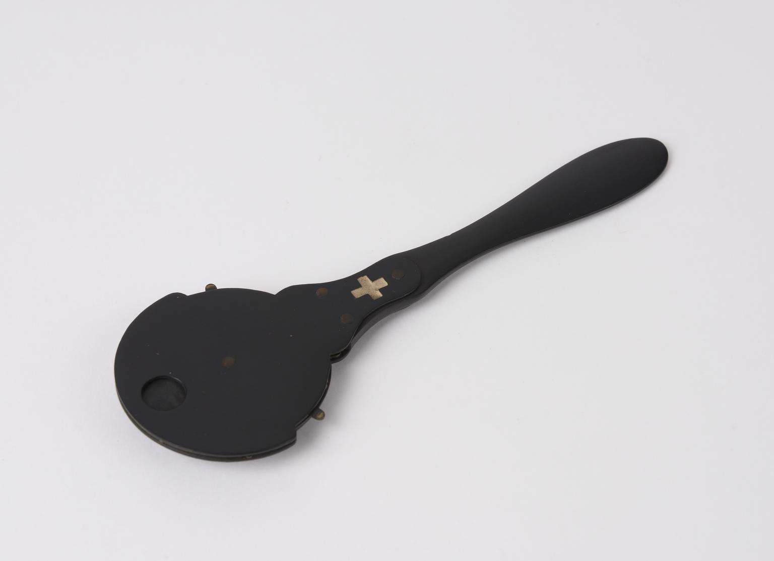 Wooden instrument containing a hand revolved disc which bears smaller ...