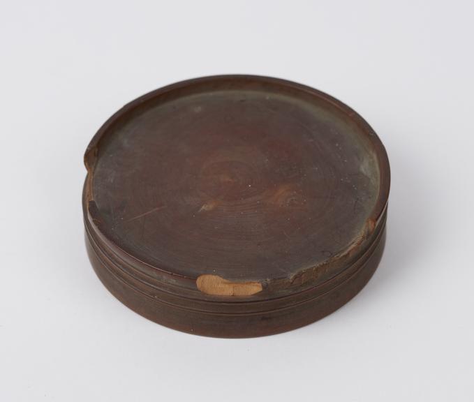 Wooden stand, circular turned block of wood with rim on top and