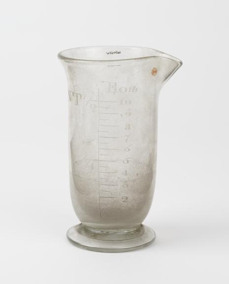 Clear glass measuring cylinder with circular base and lip