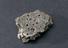 Fragment of pitted soft grey stone, amuletic