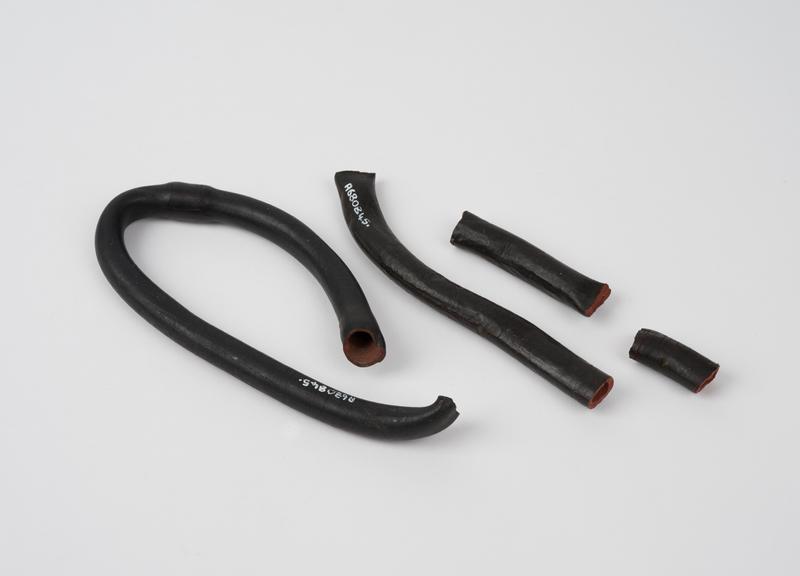 Two pieces of perished rubber tubing, one straight, one looped