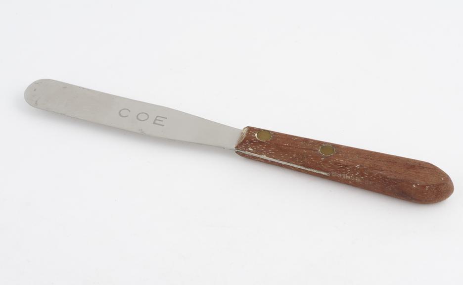 Plaster spatula, stainless steel with wooden handle, by Coe