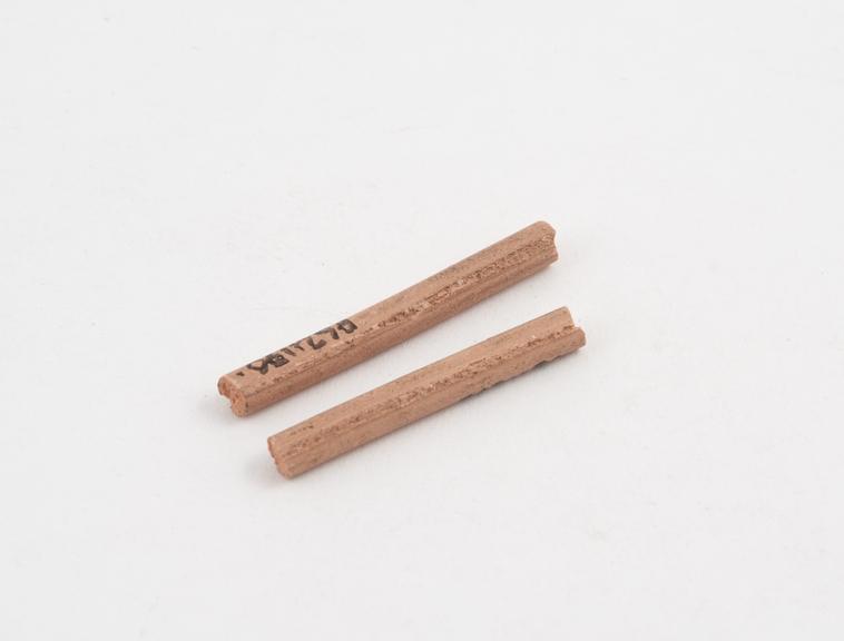 Two sticks of pink gutta percha temporary stopping