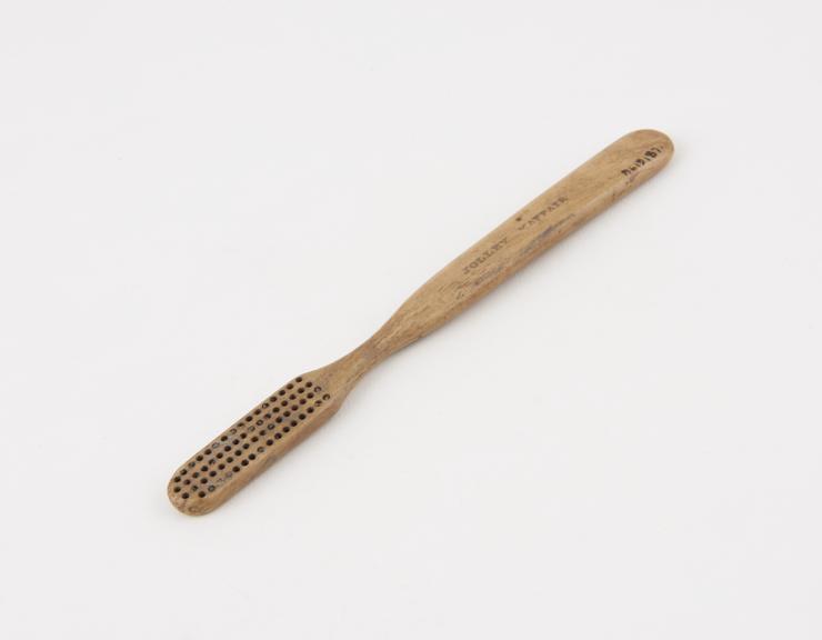 Toothbrush, bone, bristles missing, supplied by Jolley, Mayfair