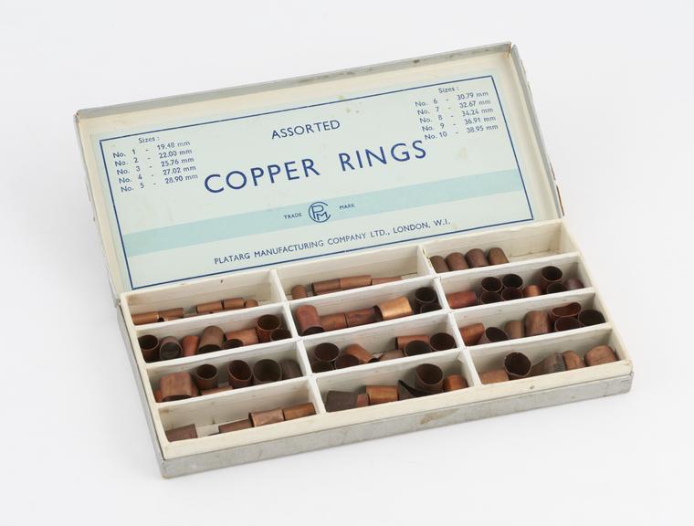 Box of assorted copper bands, by the Platarg Manufacturing Co