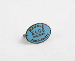 Blue oval badge with writing on the front and a screw element on the back