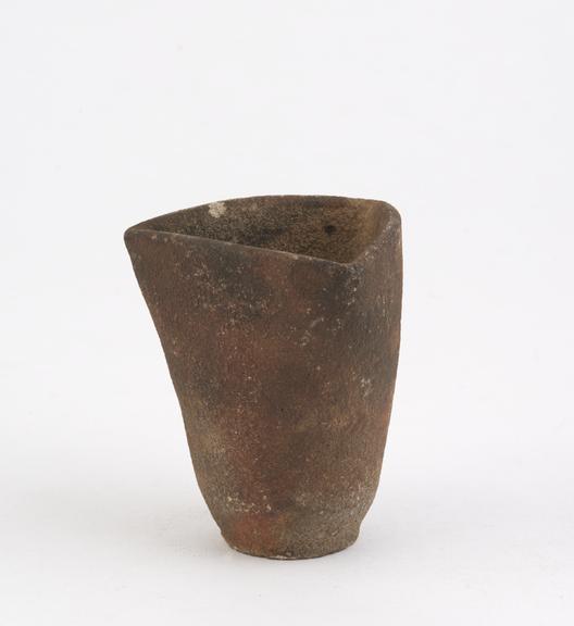 Unglazed earthenware crucible with circular base and triangular