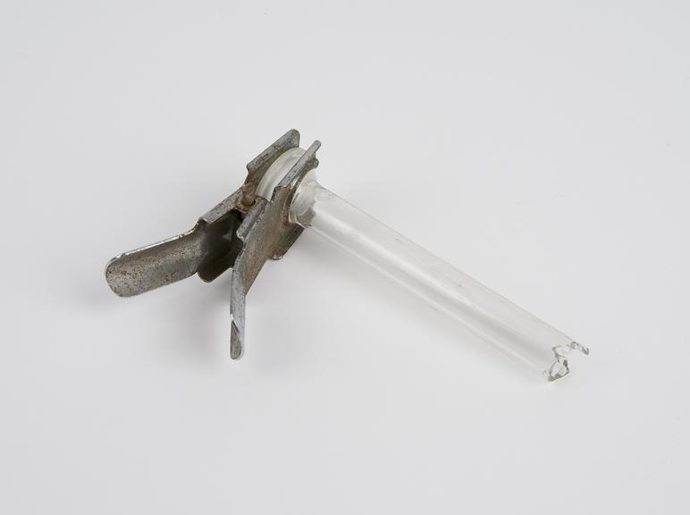 Broken glass tube with metal clamp from Glass still