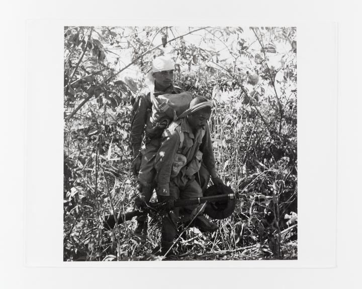 Ghurka soldier carrying wounded comrade