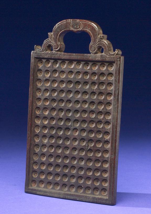 Rectangular wooden board with carved handle at top