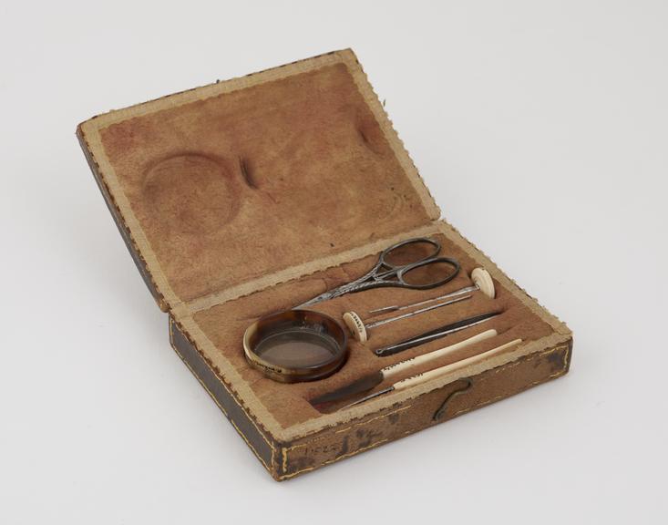 Leather covered wooden case containing 7 instruments (chiropody sets)