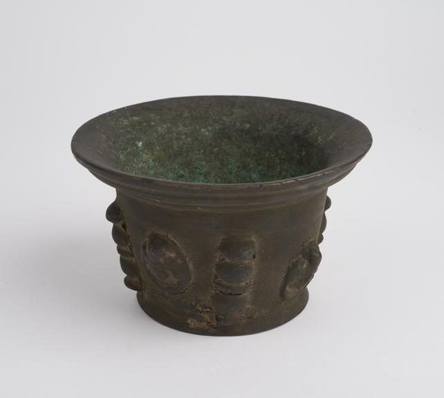 Small squat bronze mortar with flared rim and foot