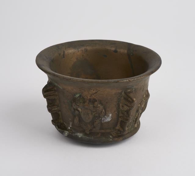 Small squat bronze mortar with flared foot and rim