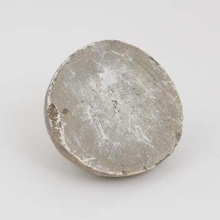 Half of a horse calculus, white/grey in colour