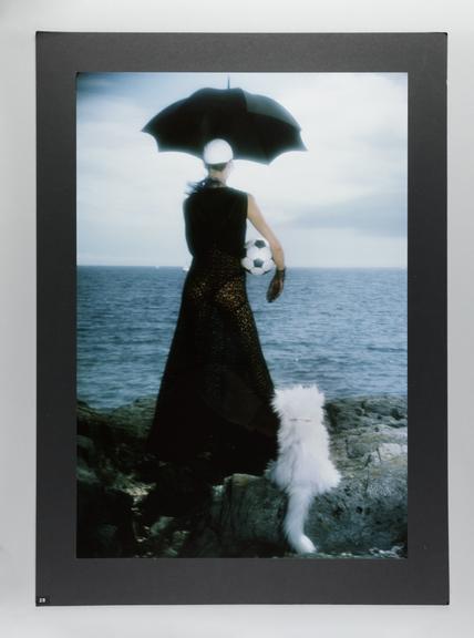 Photographic print of Clare on the beach with an umbrella