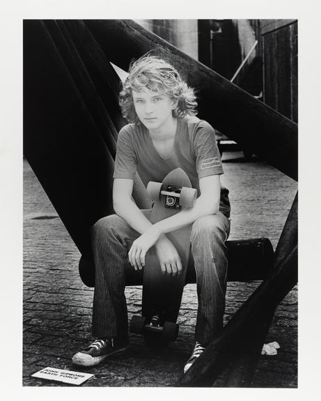 Photographic portrait of a boy with a skateboard