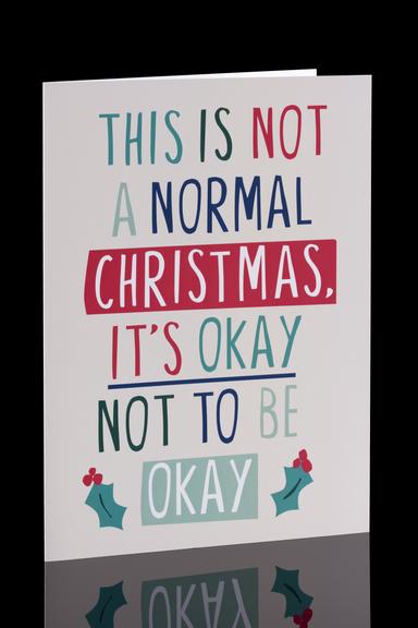 Christmas card with a neutral background with the words "This