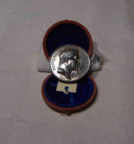 Silver-Coloured Circular Metal Medal, in Red and Blue Circular Case, Won by James Moore