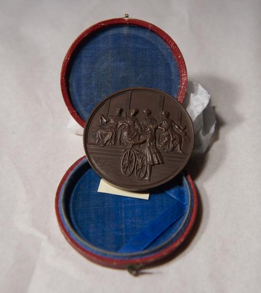 Brown-Coloured Circular Metal Medal, in Red and Blue Circular Case, Won by James Moore