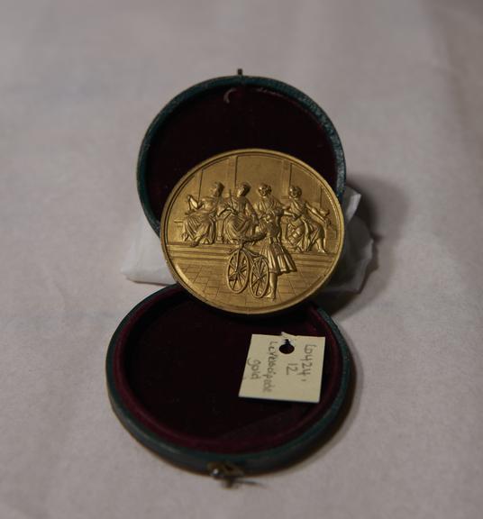 Gold-Coloured Circular Metal Medal, in Green and Red Circular Case, Won by James Moore