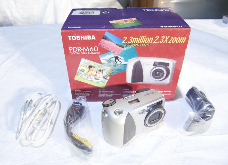 Toshiba PDR-M60 digital camera with original packaging.