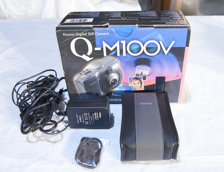 Konica Q-M100v digital camera with original packaging.