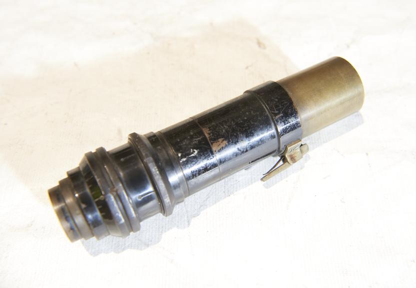 Lens, with attachment for clipping to a larger device