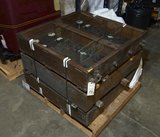 three wood and glass cupboards