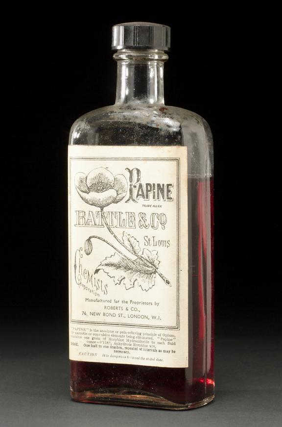 Clear glass bottle containing 'Papine' brand liquid (opium and