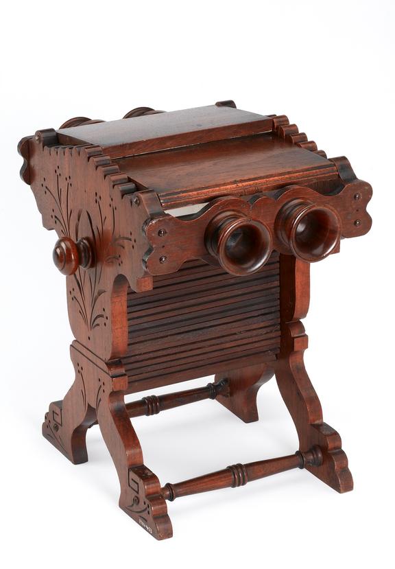 Wooden table stereoscope with carved stand.