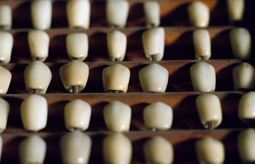 Selection of porcelain crowns on mahogany tray