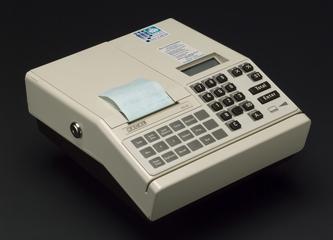 Electronic payment terminal, with captive power and telephone line leads, one roll of paper, two keys, screws, and operating instructions