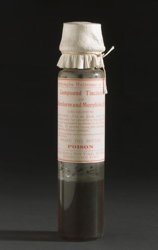 Glass phial with kid covering containing Compound Tincture of Chloroform and Morphine (Chlorodyne). 110 mm x 22 mm diameter