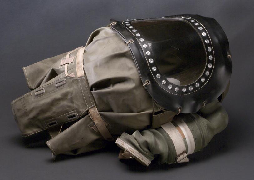 Baby's gasmask of khaki green rubber with metal frame