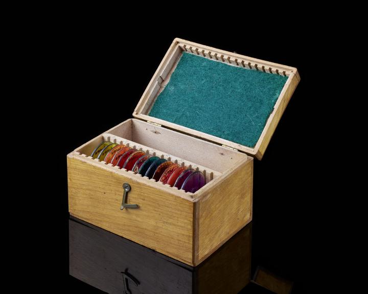 Wooden box containing 14 coloured filteres.