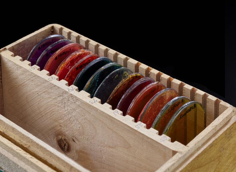 Wooden box containing 14 coloured filteres.