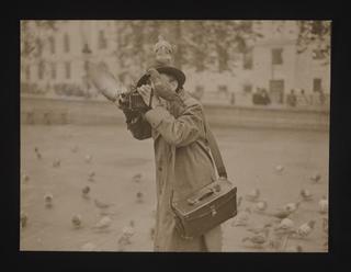 A photographer with pigeons, Trafalgar Square, London