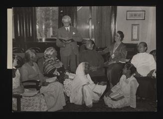 A photographic print of Ayahs and Amahs listening to prayers at the Ayah's Home