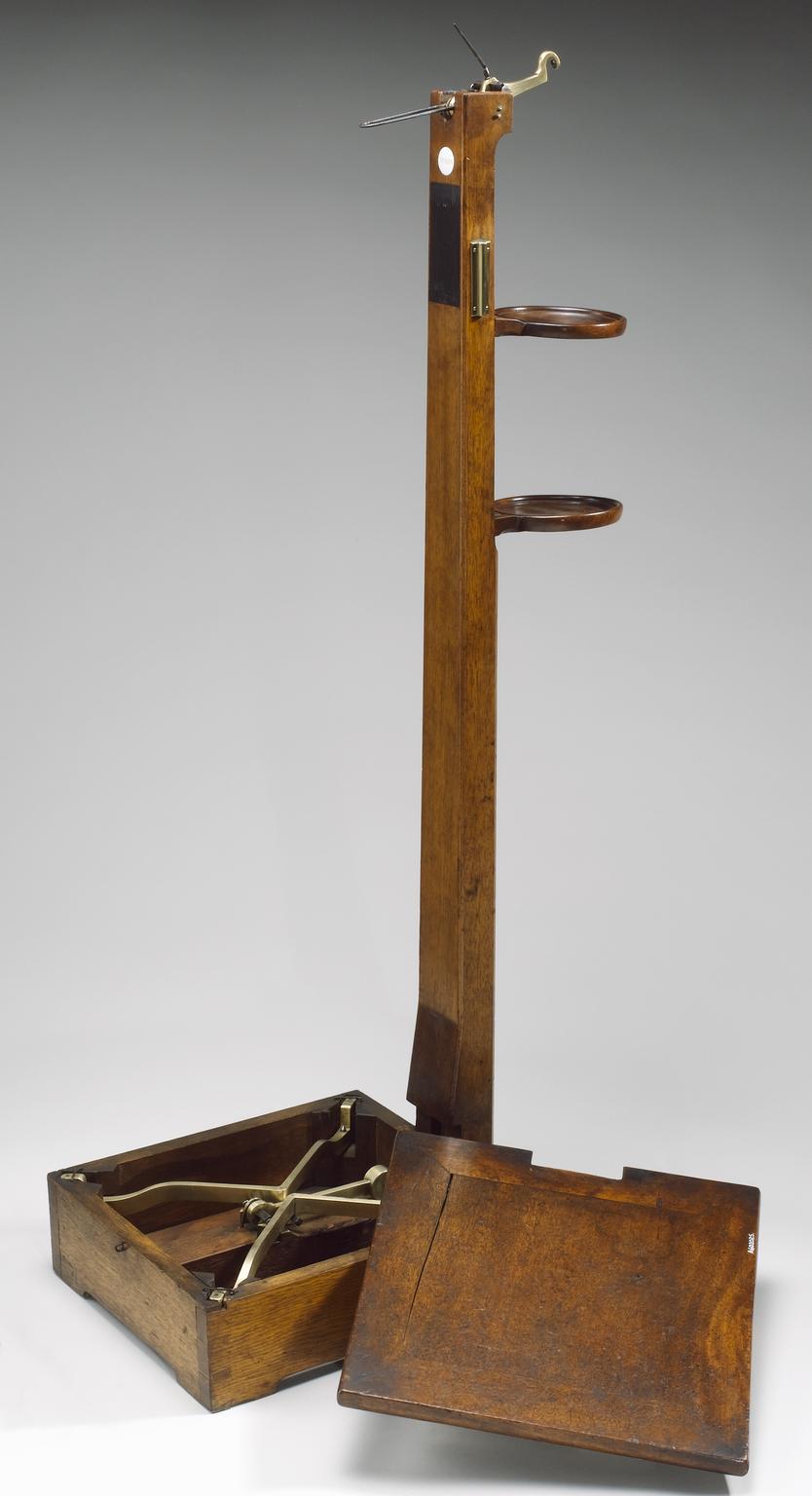 Personal weighing scales with two separate circular brass fittings and ...