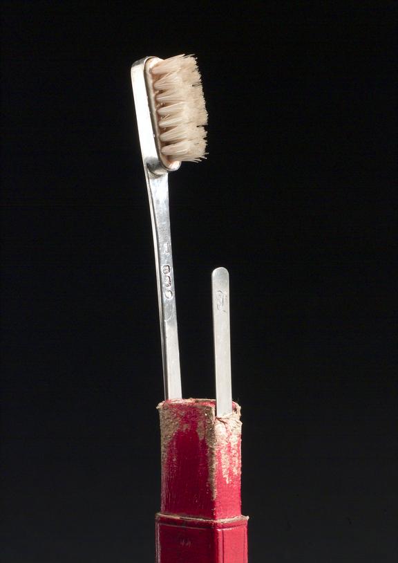 Toothbrush set, in rectangular red leather tooled pull off case