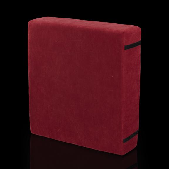 Red square cushion with two strips of Velcro on the back