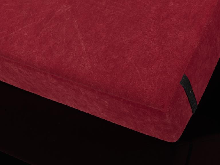 Red square cushion with two strips of Velcro on the back